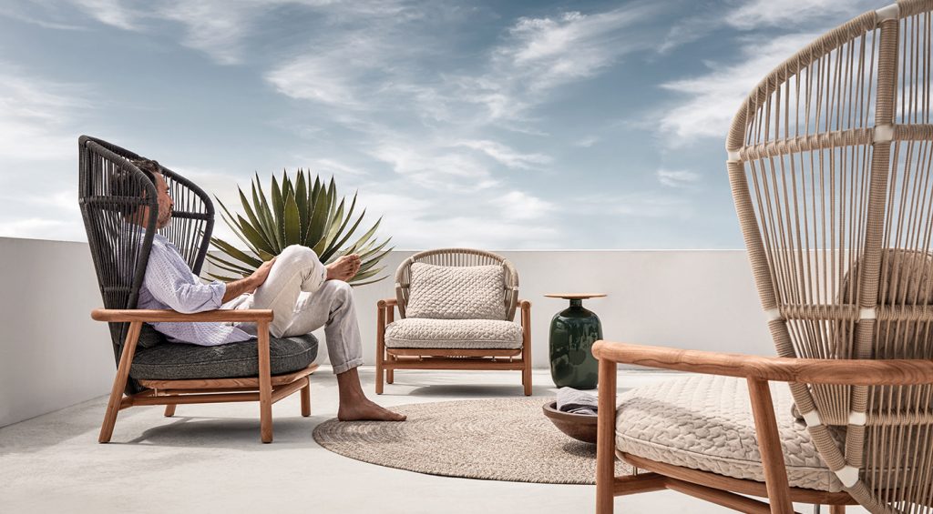 CHAPLINS Fern Collection by Gloster. Inspired by the delicate fronds of an unfurling leaf, the Fern Chair by Sebastian Herkner is a stately yet cosy outdoor lounge chair. Harnessing natural materials such as teak and rope, it creates the impression that one is being enveloped by Mother Nature herself.