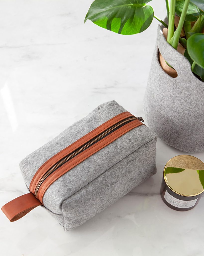 This luxury Washbag is the perfect travel accessory, keeping your toiletries safe and all in one place.  Made from recycled plastic bottle felt fabric with vegetable tanned leather accents. Fully lined with water resistant lining.