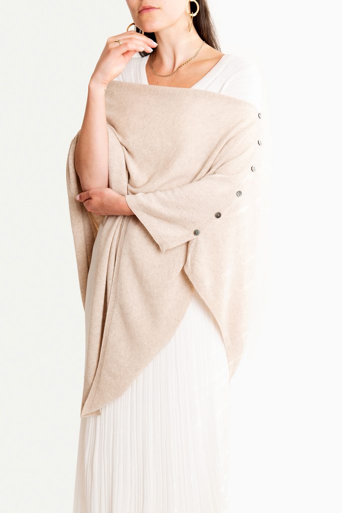 Knüg's luxuriously soft cashmere button wraps are gloriously multi-purpose and can be worn in many ways, including as a shrug, cardigan, poncho, shawl, and scarf. 