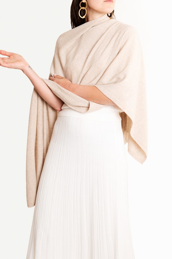 Knüg's luxuriously soft cashmere button wraps are gloriously multi-purpose and can be worn in many ways, including as a shrug, cardigan, poncho, shawl, and scarf. 