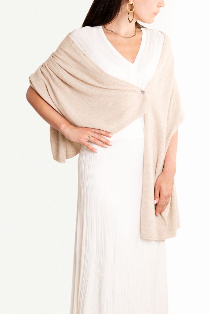 Knüg's luxuriously soft cashmere button wraps are gloriously multi-purpose and can be worn in many ways, including as a shrug, cardigan, poncho, shawl, and scarf. 