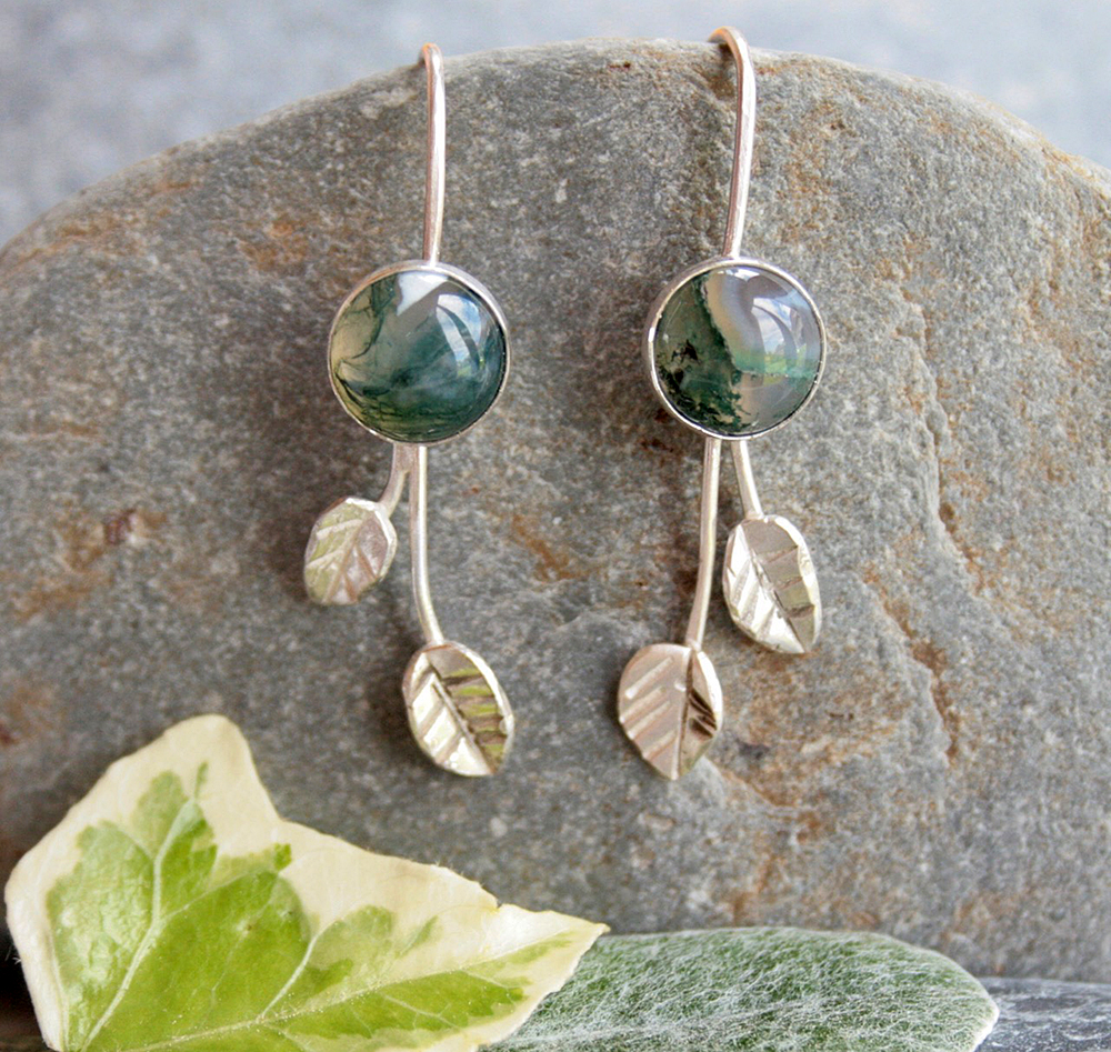 Long Silver and Moss Agate Leaf Earrings by Thistledown Wishes
 These sterling silver and moss agate earrings have been handmade in Scotland by myself. They are like a little piece of woodland to wear in your ears with the gorgeous moss agate and little silver leaves. Materials: sterling silver, moss agate. Dimensions: 8 mm diameter moss agate, total length is 35 mm.