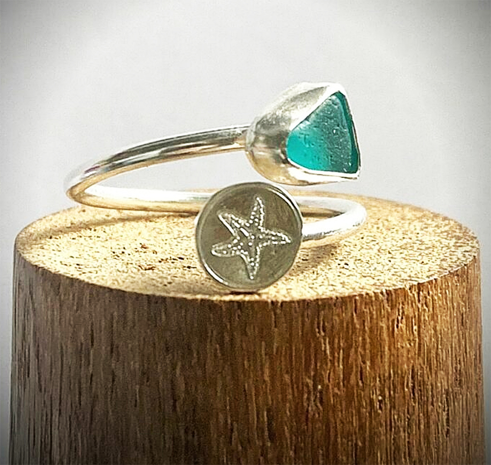 Turquoise Sea Glass Adjustable Sterling Silver Ring with Silver Starfish by Silverre

Rare turquoise sea glass set in a fine silver handmade bezel and set on a Sterling silver adjustable ring with a Sterling Silver Starfish. This ring is approximately an R1/2 UK or 9 USA size. If you let me know your approximate ring size I will adjust it before posting obviously any adjustment will affect the placing of the Sea Glass and Starfish.