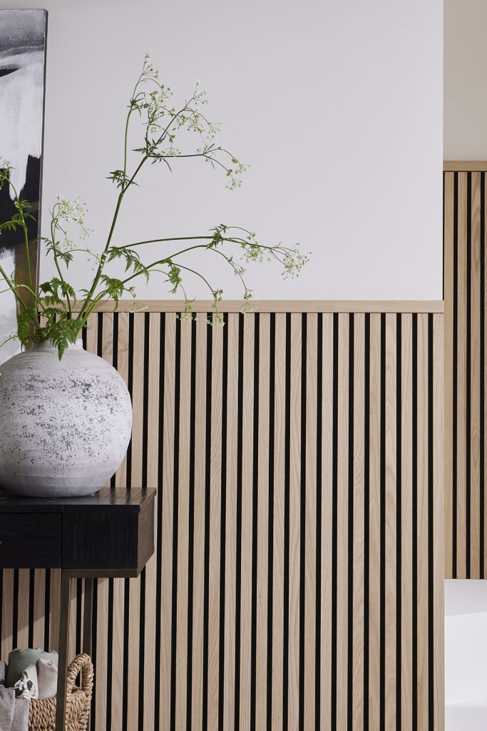SlatWall Midi Natural Oak Top Trim
 Expertly crafted at our UK workshop, this style is made from oak veneer, colour-coordinating MDF and black recycled felt. The slatted layout and dense backing material help to absorb sound and enhance your room's acoustics.