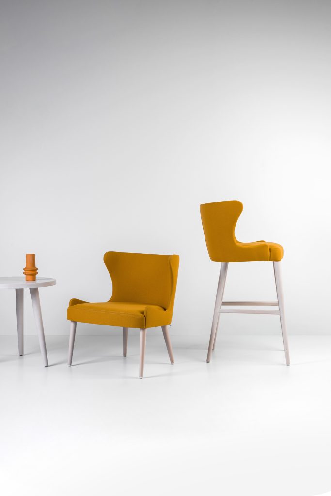 The curved lines which create harmonious shapes define this model. The Wave Collection was born with a contemporary, elegant and sophisticated style. Chair, armchair, bar stool and lounge are available in either solid beech or ash frame, and come with either fabric or vinyl upholstery.