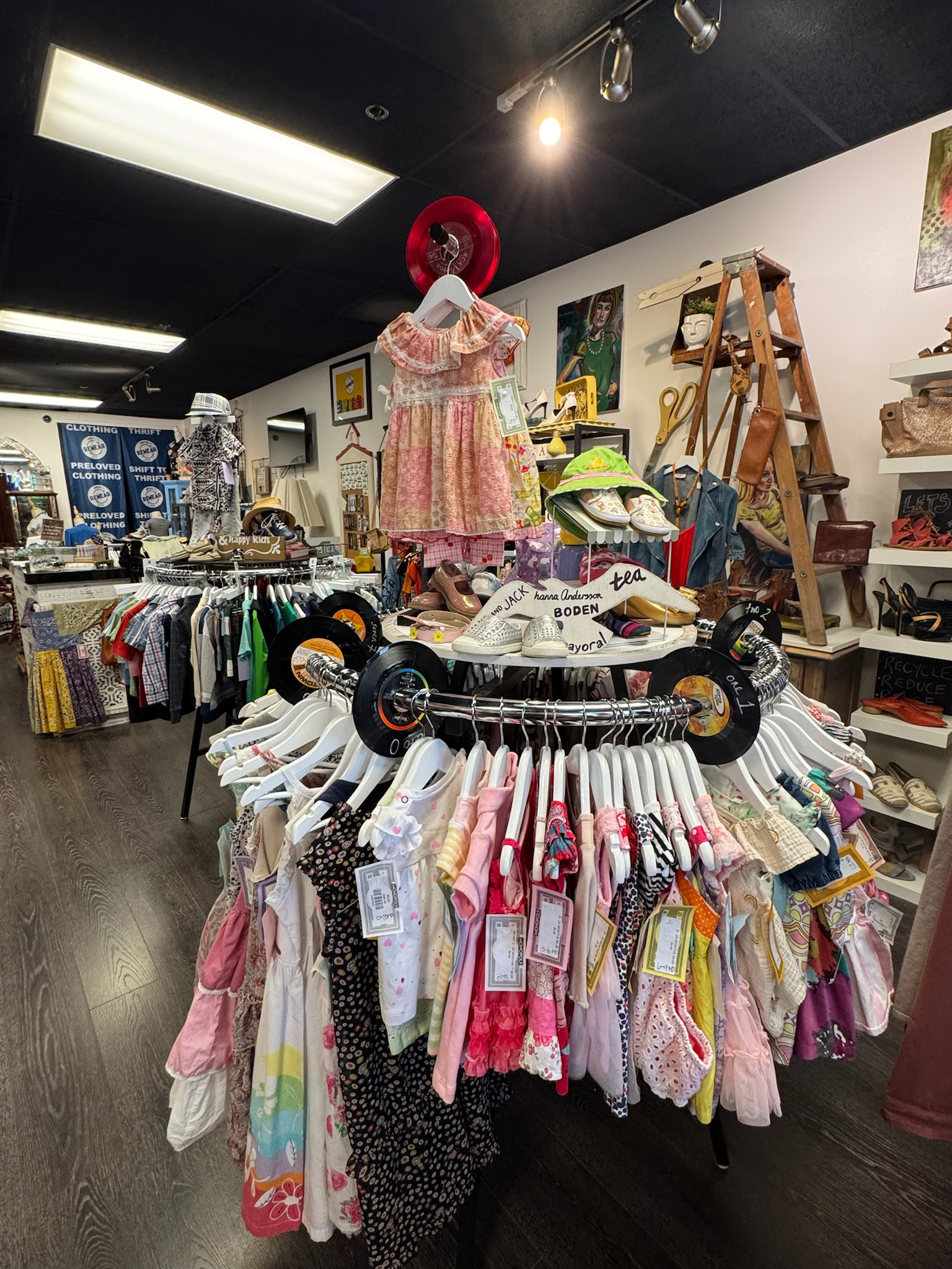Project ReWear’s warm, welcoming retail space filled with thoughtfully merchandised preloved pieces for all ages. Photo courtesy of Project ReWear.