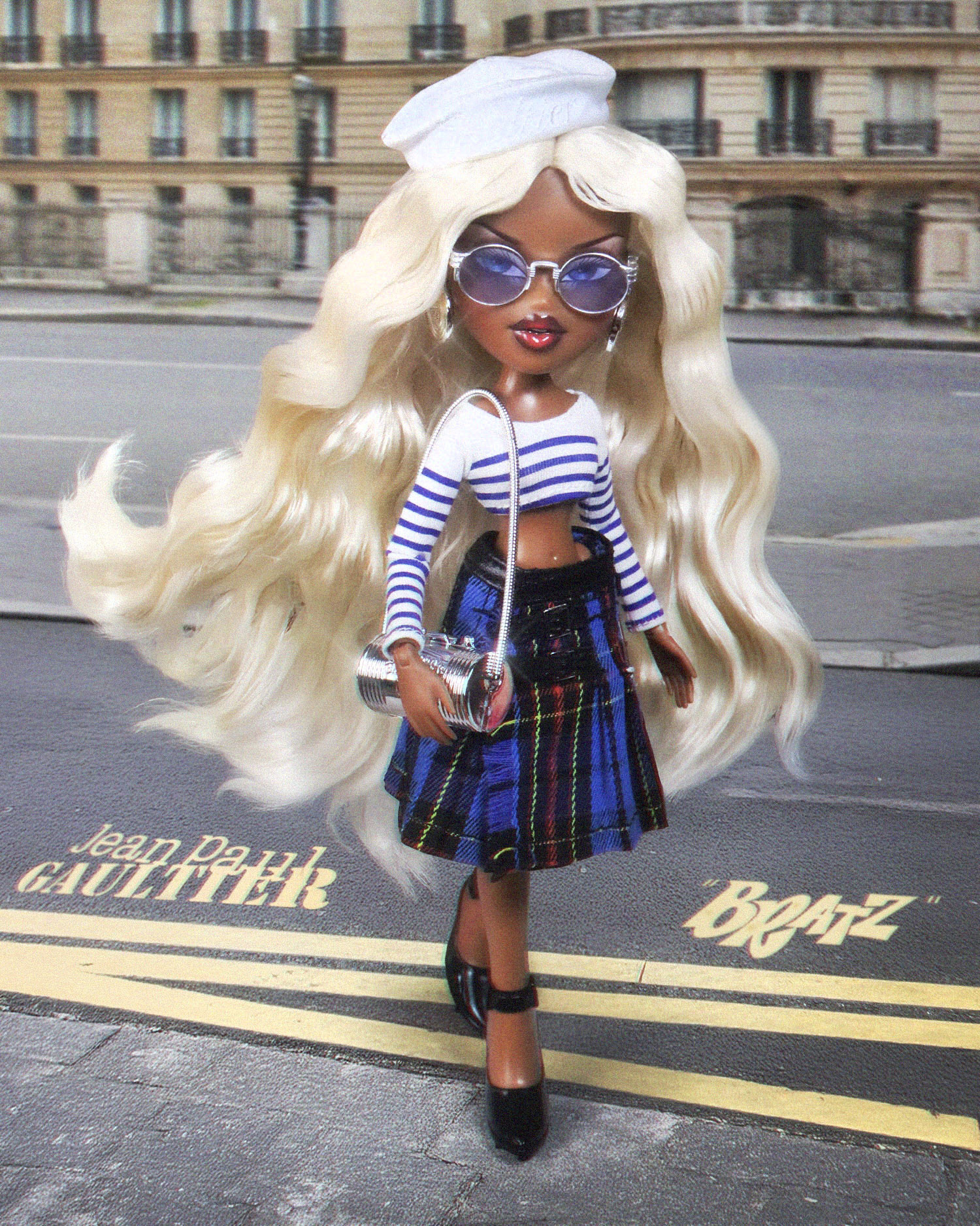 Bratz® x Jean Paul Gaultier Collector Doll - Blue Dress
In one of the most iconic doll collaborations to date, Bratz inducts Jean Paul Gaultier into their designer doll collab hall of fame. Fearless fashion meets Parisian couture in this ultra-premium doll. Sasha's second look is inspired by the Jean Paul Gaultier ready-to-wear collection and channels a nautical spirit with a chic punk twist, featuring a crisp marinière crop top, a pleated tartan mini skirt with buckle accents and a white sailor hat that sits atop her waist-length blonde waves - a first for Sasha!