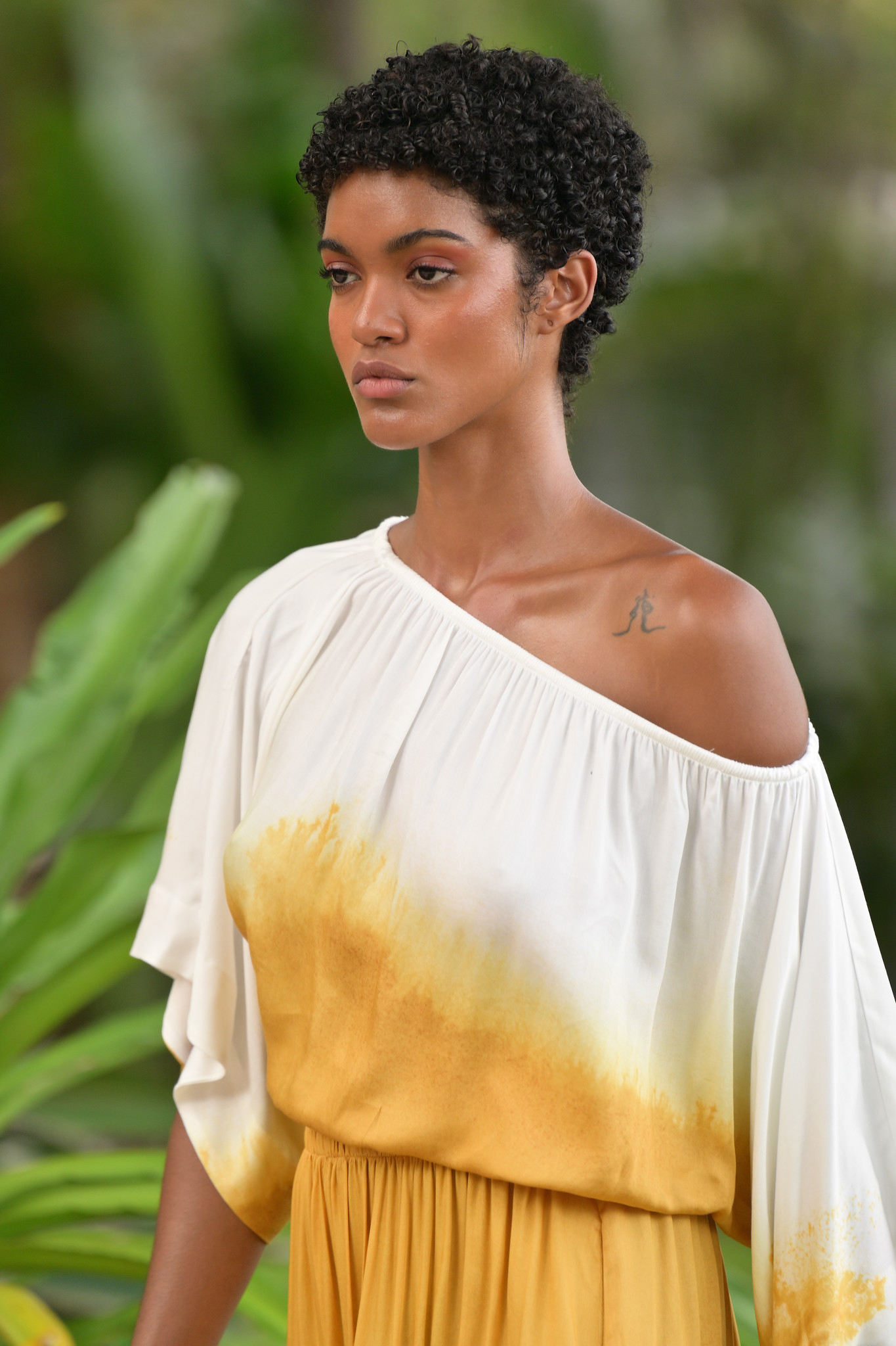 A model walks down the runway at the SIGAL fashion show at DeLido Beach Bar at Ritz Carlton, South Beach.
