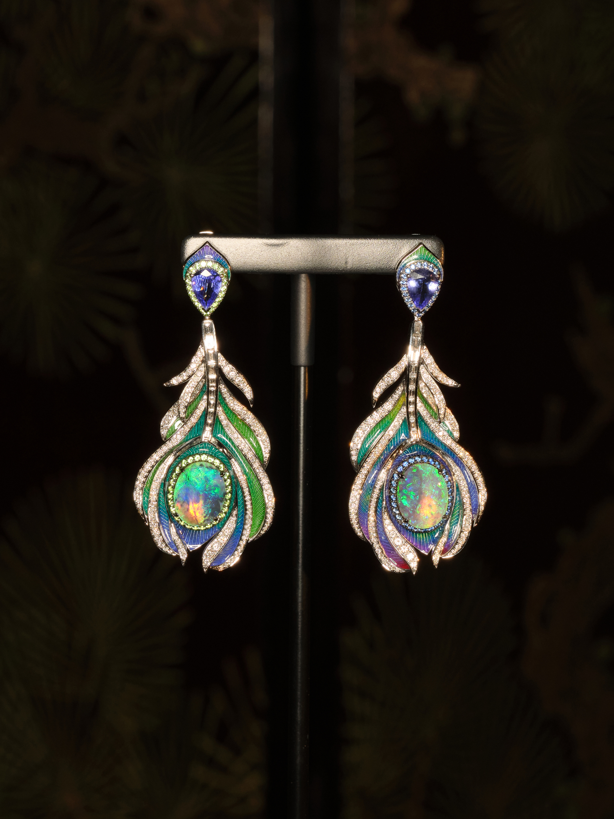 Black Opal Earrings
Main stones: Pair of Australian Black Opals, 5.78 carats. Side stones: 312 Round Brilliant Cut Diamonds, 2.13 carats | 49 Sapphires, 0.35 carats. 49 Tsavorites, 0.40 carats | 2 Tanzanites, 1.61 carats. Set in 18-carat white gold.