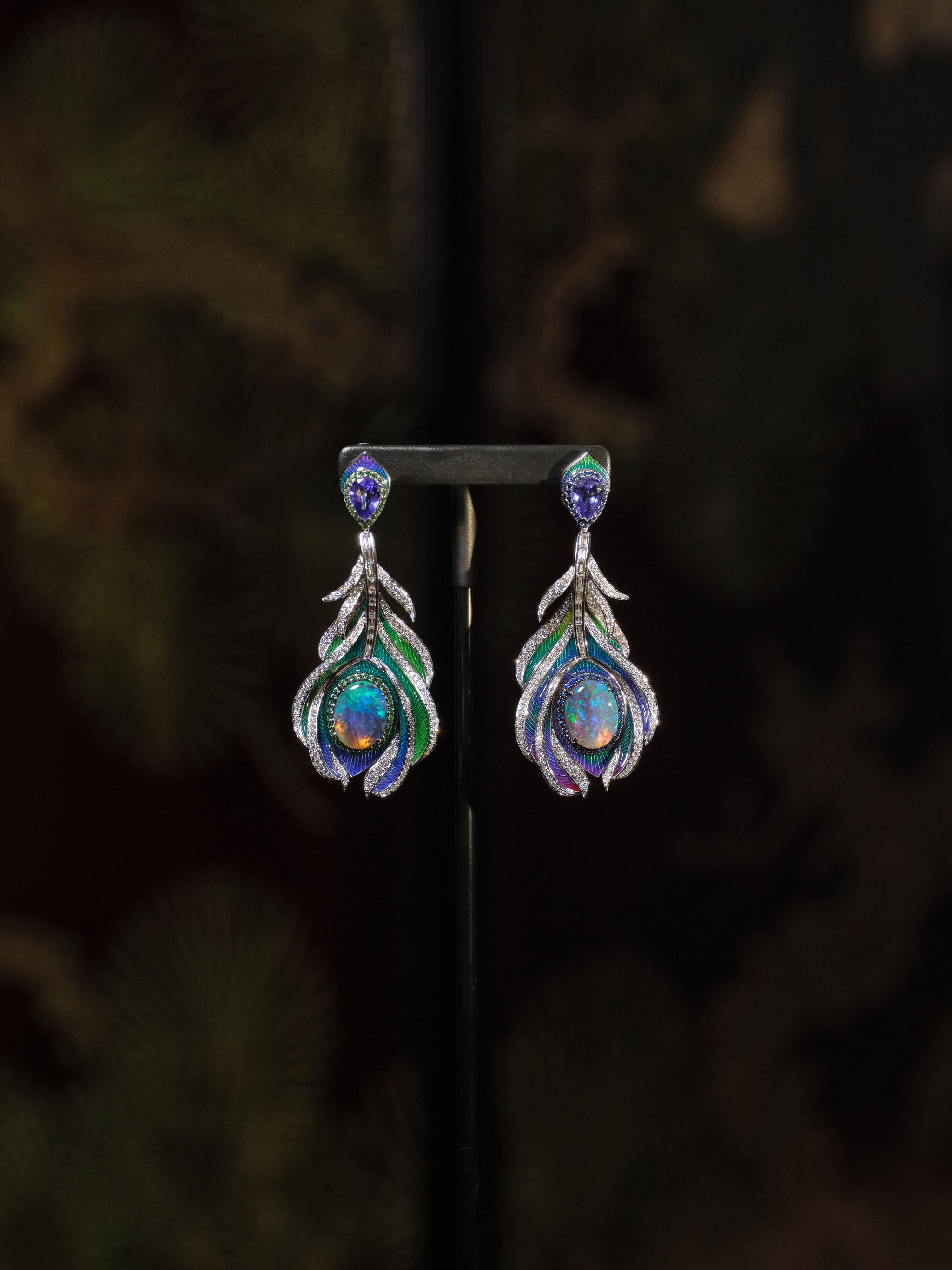 Black Opal Earrings
Main stones: Pair of Australian Black Opals, 5.78 carats. Side stones: 312 Round Brilliant Cut Diamonds, 2.13 carats | 49 Sapphires, 0.35 carats. 49 Tsavorites, 0.40 carats | 2 Tanzanites, 1.61 carats. Set in 18-carat white gold.