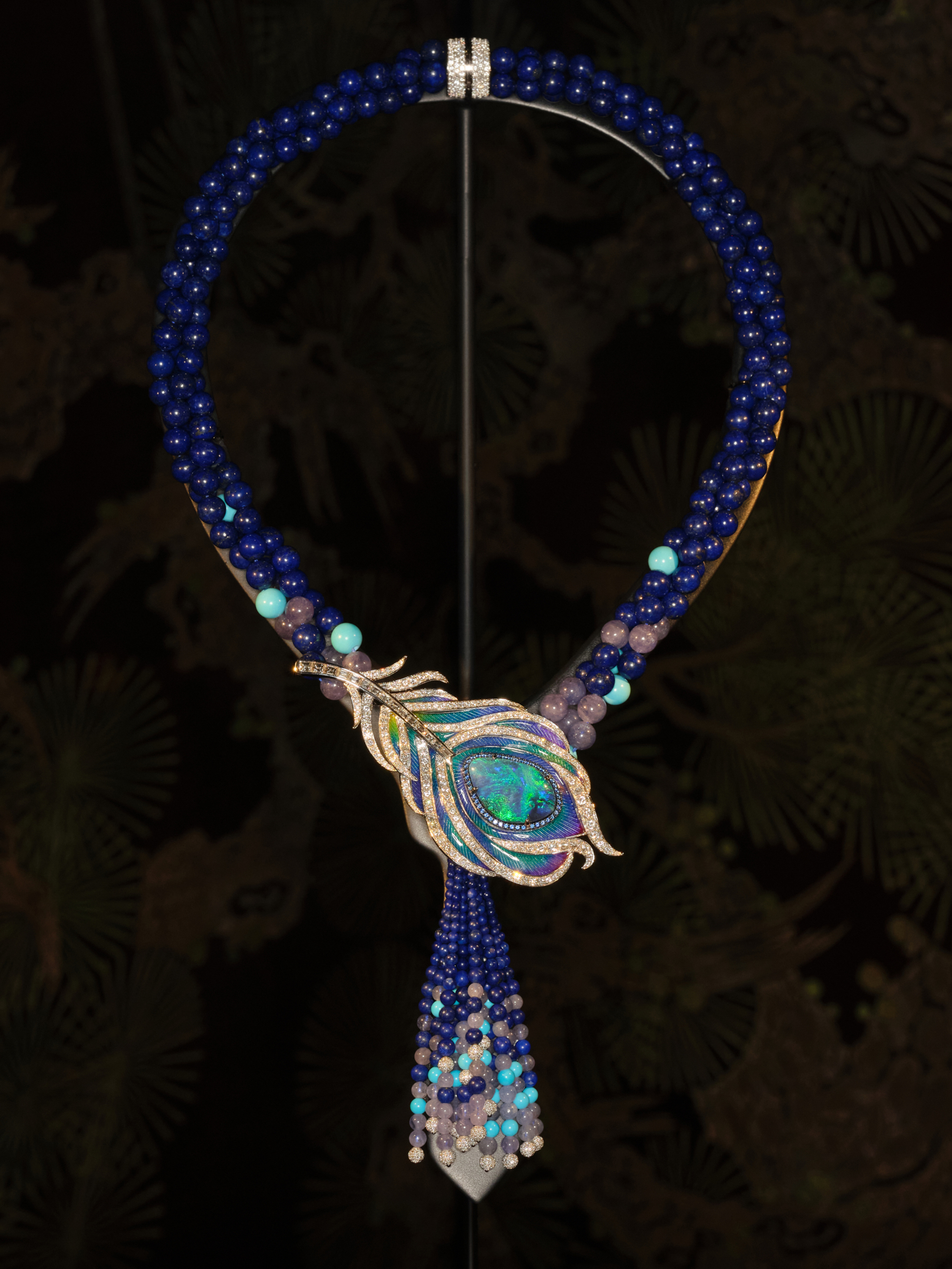 Black Opal Necklace / Brooch
Main stone: Australian Black Opal, 11.88 carats. Side stones: 1205 Round Brilliant Cut Diamonds, 9.50 carats | 44 Sapphires, 0.45 carats. 28 Turquoises, 27.90 carats | 70 Tanzanites, 77.53 carats | 366 Lapis Lazuli, 537.39 carats. Set in 18-carat white gold.