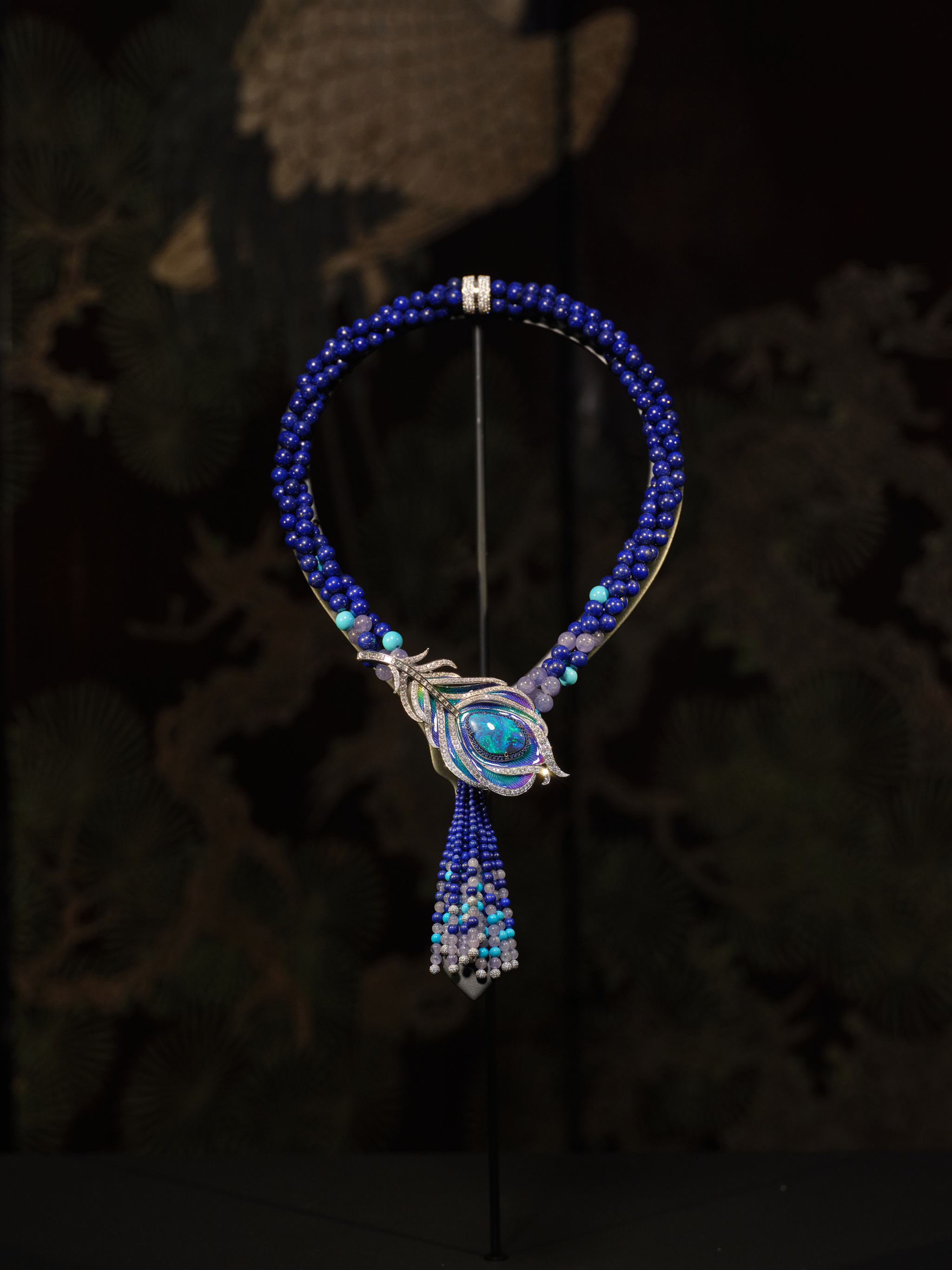 Black Opal Necklace / Brooch
Main stone: Australian Black Opal, 11.88 carats. Side stones: 1205 Round Brilliant Cut Diamonds, 9.50 carats | 44 Sapphires, 0.45 carats. 28 Turquoises, 27.90 carats | 70 Tanzanites, 77.53 carats | 366 Lapis Lazuli, 537.39 carats. Set in 18-carat white gold.