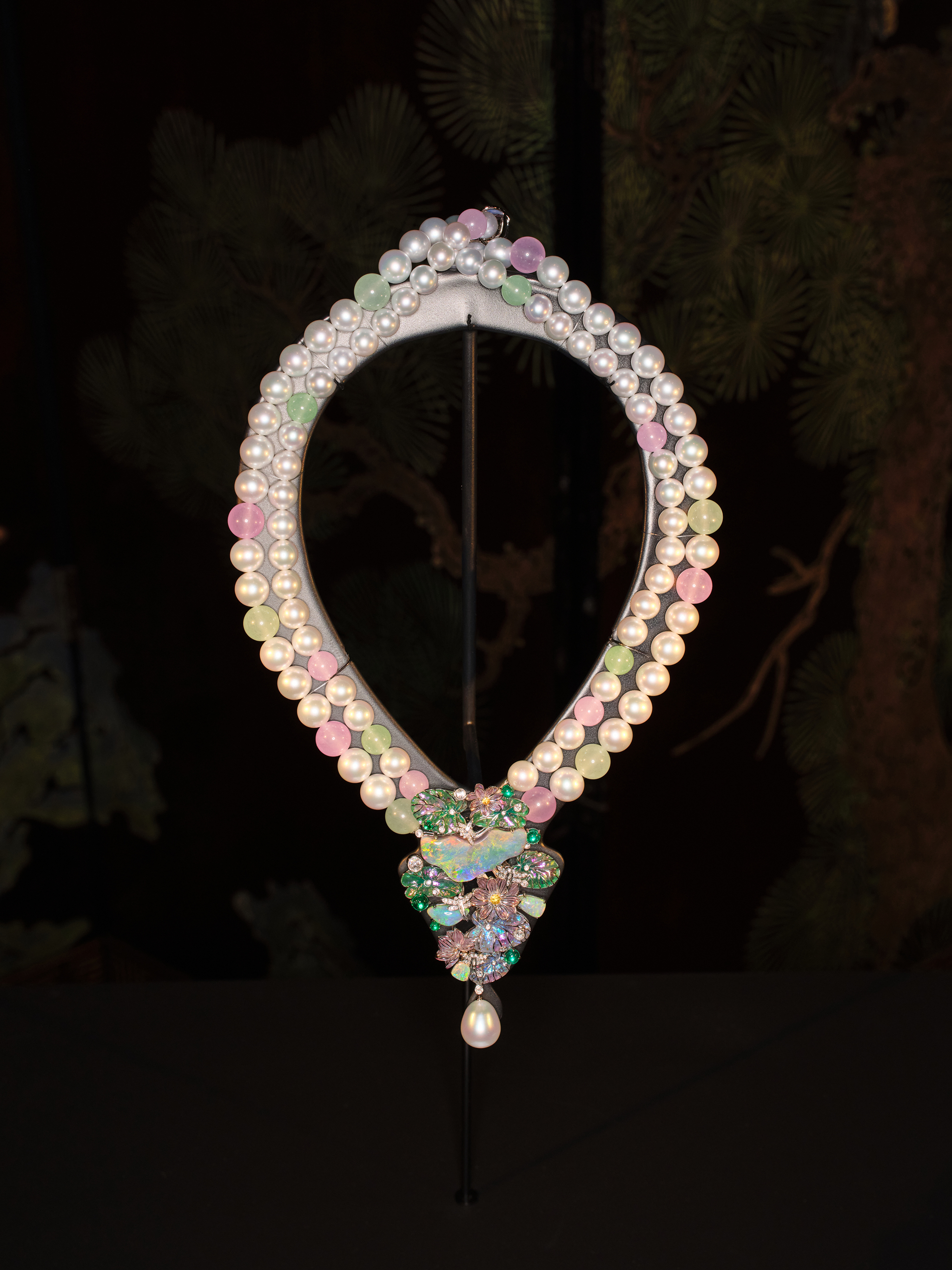 Black Opal and Plique-à-Jour Enamel Necklace
Main stones: Black Opal, 23.33 carats. Accent stones: 3 Opals, total 5.28 carats | 6 Emeralds, total 2.80 carats | 2 Yellow Sapphires, total 0.30 carats. 81 Diamonds, total 1.20 carats | 9 Green Chrysoprase Beads | 10 Purple Chalcedony Beads. Drop-shaped White Pearl, 21.43 carats | 77 Australian White Pearls (Venus Grade), 9-12 mm. Set in 18-carat white gold.