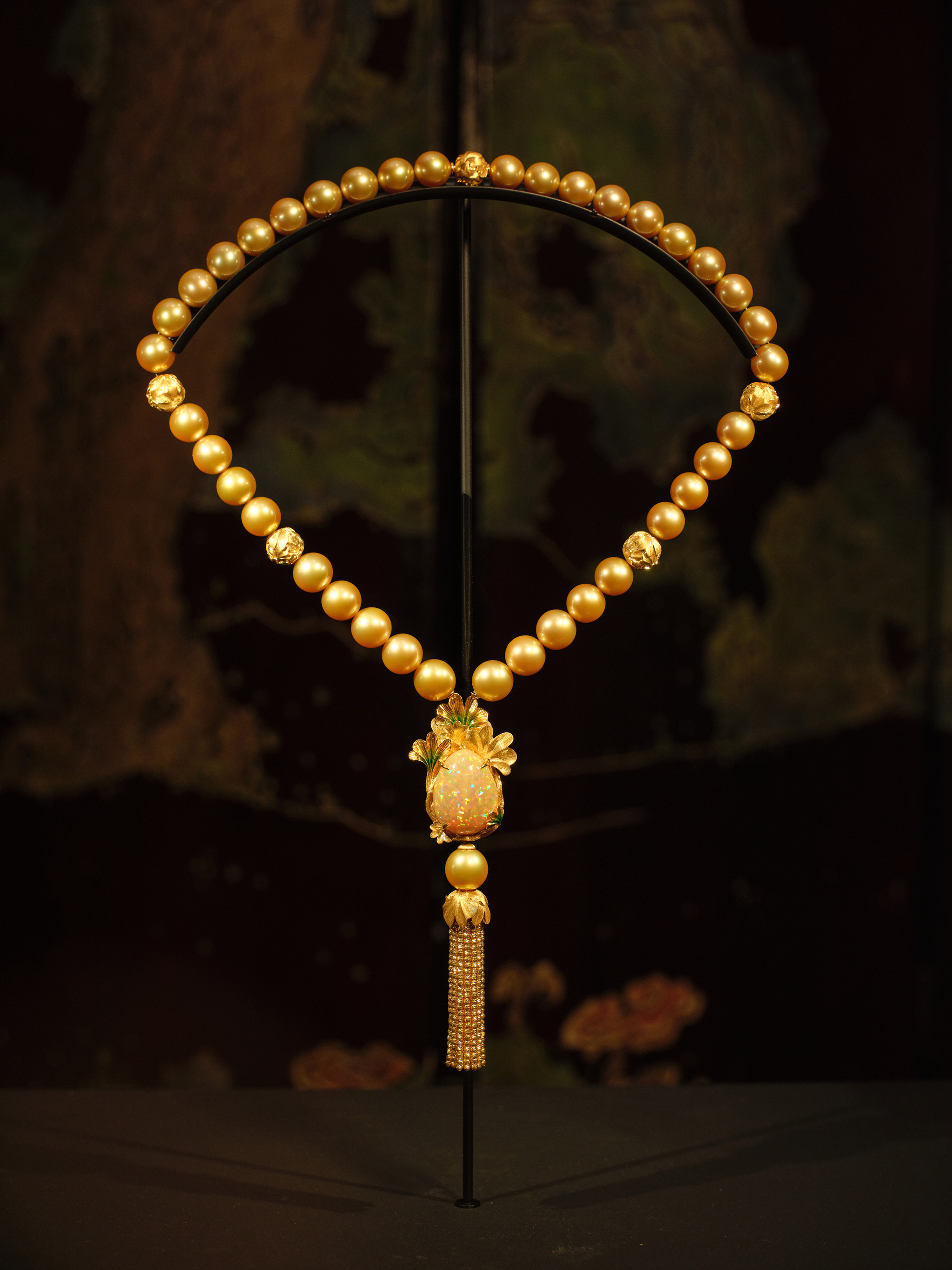 Opal and Golden Necklace
Main stone: Opal, 43.95 carats. Side stones: 65 Golden South Sea Pearls, 14 - 16.3 mm. Set in 18-carat White Gold.