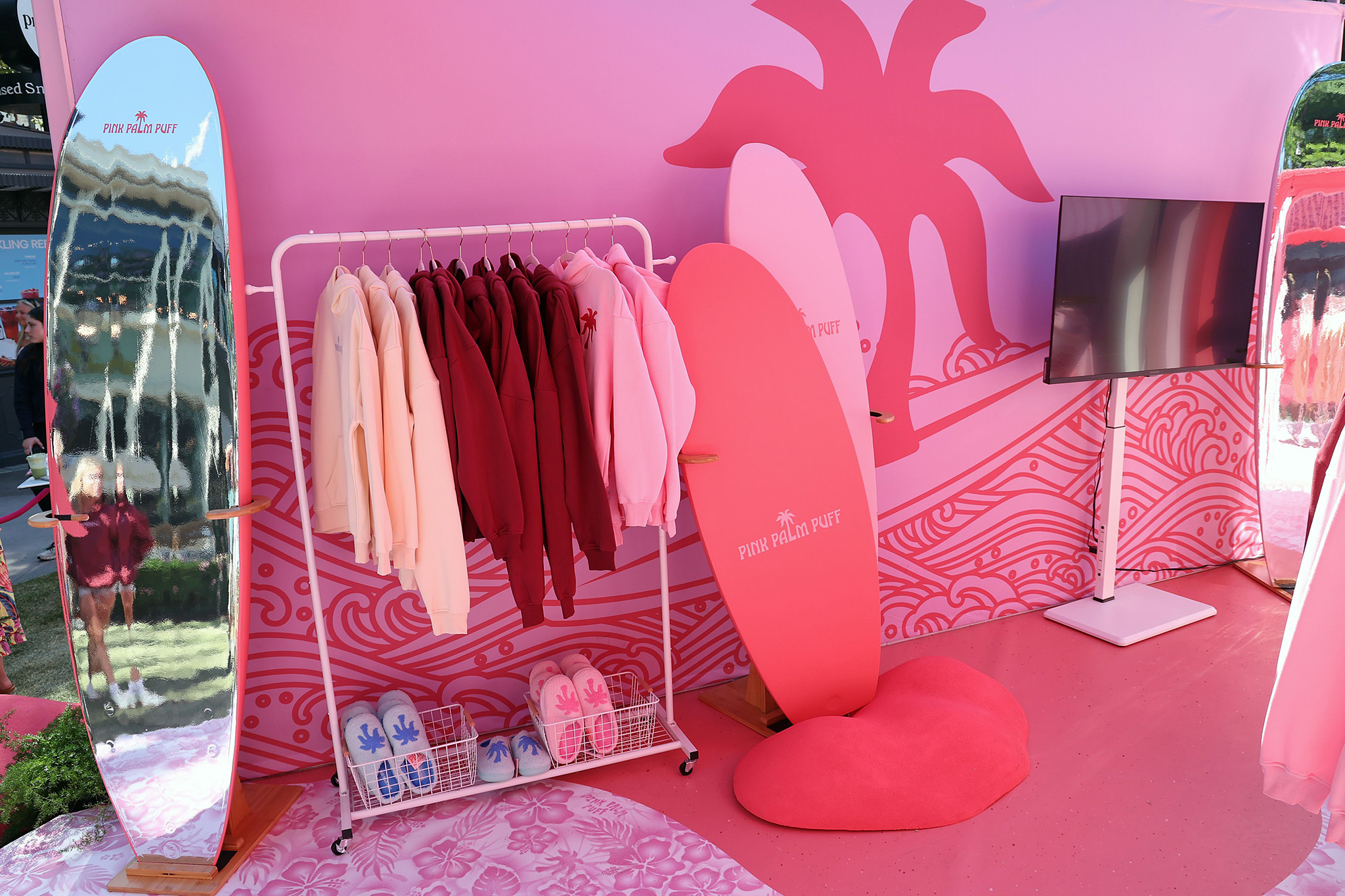 LOS ANGELES, CALIFORNIA - AUGUST 08: Pink Palm Puff hoodies and slippers are seen during the Pink Palm Puff VIP Pop-Up Event at The Grove on August 08, 2025 in Los Angeles, California. (Photo by Phillip Faraone/Getty Images for Pink Palm Puff)