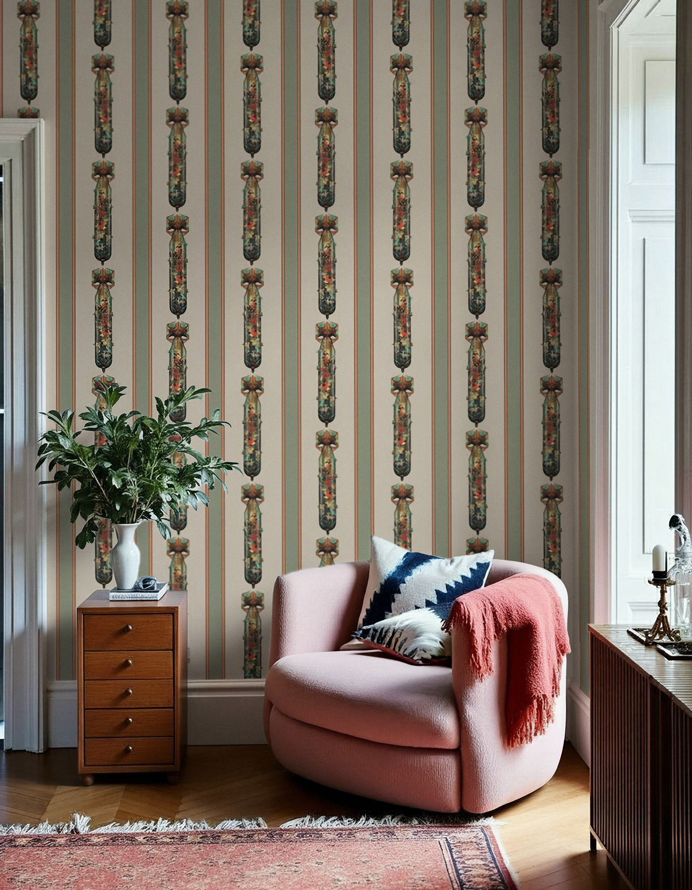 Flower Bomb by Magnus Gjoen for Feathr Flower Bomb wallpaper by Magnus Gjoen takes a formal Georgian striped design and add a touch of humour and complexity into the mix. The larger stripes of the cream flower bomb wallpaper feature a stylized bomb against a tranquil background as a way of showing how extremes often occur simultaneously in human existence.