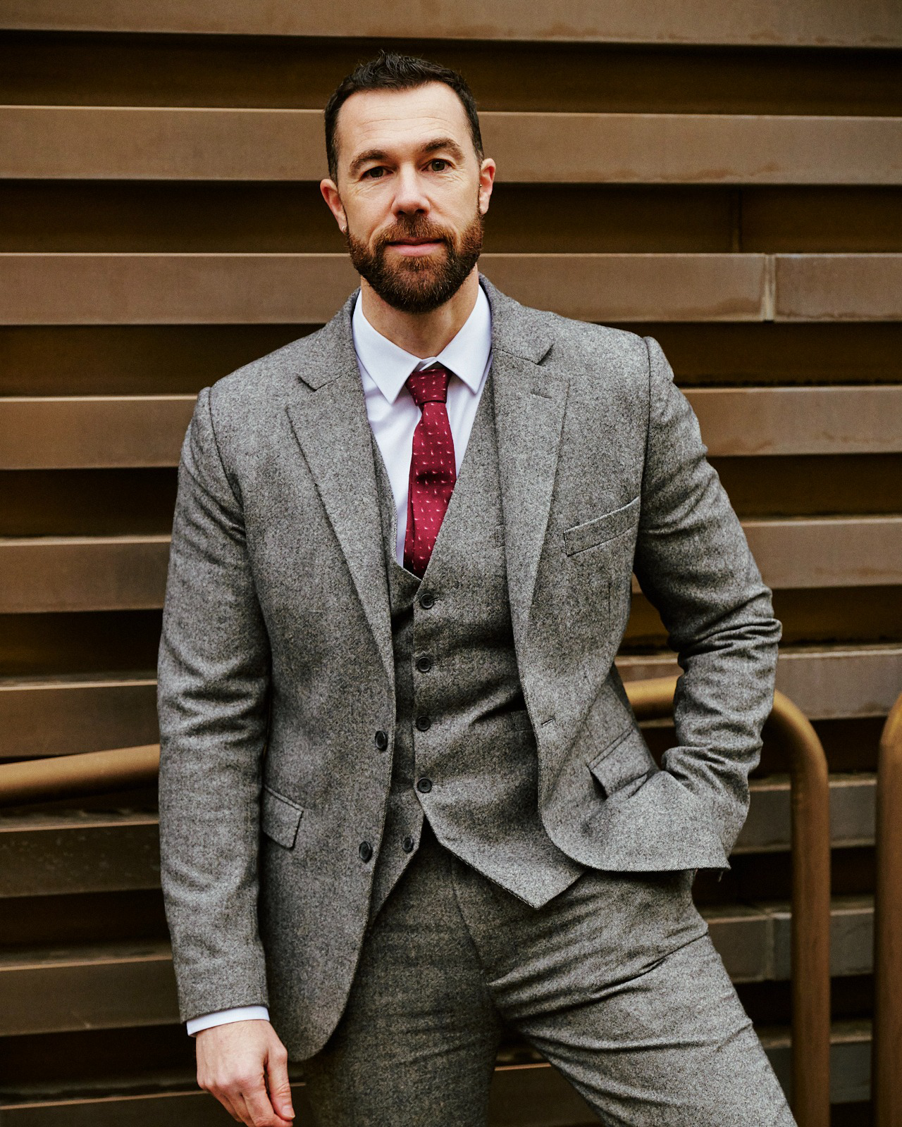 Grey Tweed Three-piece Suit with Loafers This look combines a bespoke grey three-piece herringbone tweed suit made from a grey wool blend tweed fabric, which adds texture and a classic yet modern air ideal for autumn and winter events, with loafers that round off the outfit with an elegant and relaxed touch at the same time. The waistcoat, jacket, and matching trousers create a sophisticated and timeless silhouette, perfect for those seeking a refined style, comfort and personality. (Image credits: Jonathan Blasco https://www.instagram.com/jonathan.blasco/ Styled by Hockerty, Photography by Alessandro Michelazzi https://www.instagram.com/alessandromichelazzi/)